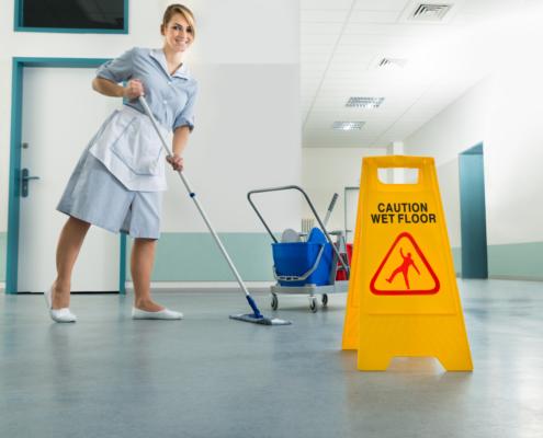 Janitor With Mop And Wet Floor Sign